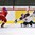 LUCERNE, SWITZERLAND - APRIL 19: Slovakia's Adam Huska #30 reaches out to poke the puck away from Russia's Kirill Kaprizov #21 during preliminary round action at the 2015 IIHF Ice Hockey U18 World Championship. (Photo by Matt Zambonin/HHOF-IIHF Images)